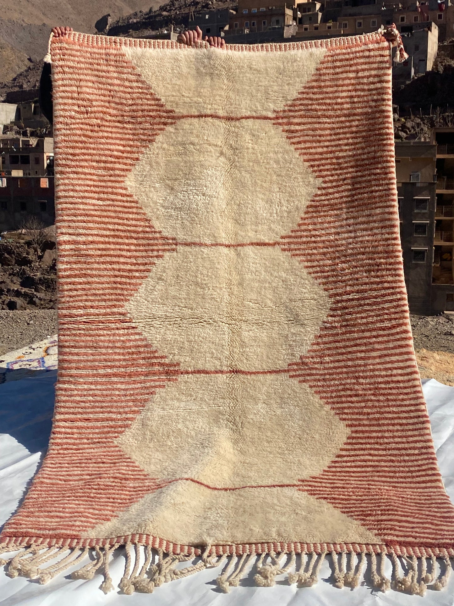 Beni Ourain rugs originate from the Atlas Mountains of Morocco and are characterized by their distinctive, neutral-toned, and geometric designs. These handwoven rugs often feature a plush pile and are made by the Berber tribes, size is 255x150 cm