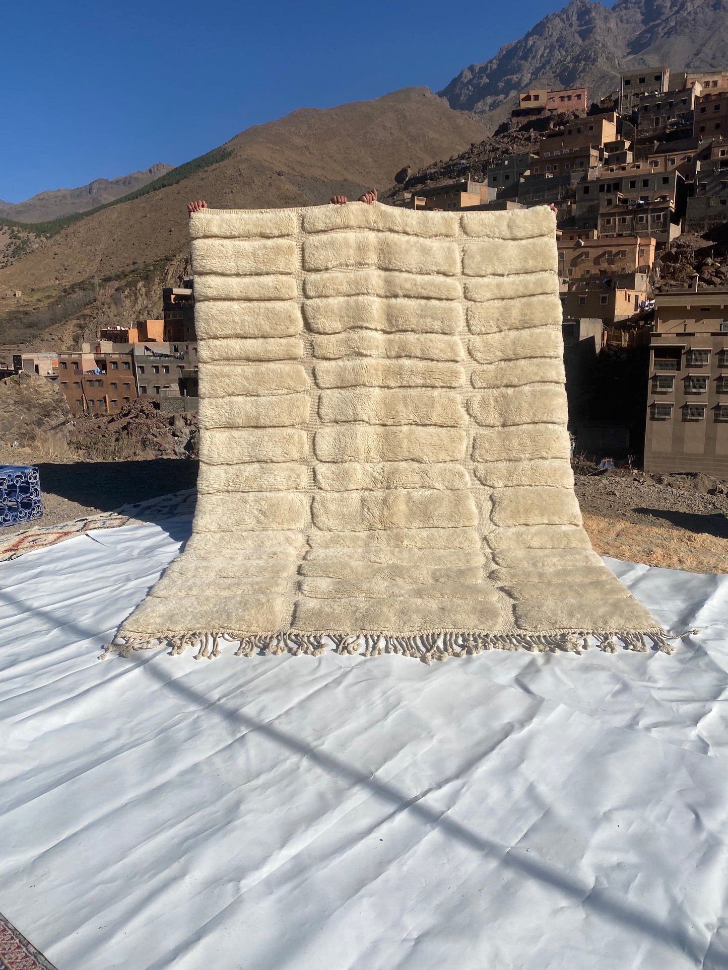 Beni Ourain rugs originate from the Atlas Mountains of Morocco and are characterized by their distinctive, neutral-toned, and geometric designs. These handwoven rugs often feature a plush pile and are made by the Berber tribes, size is 285x195 cm