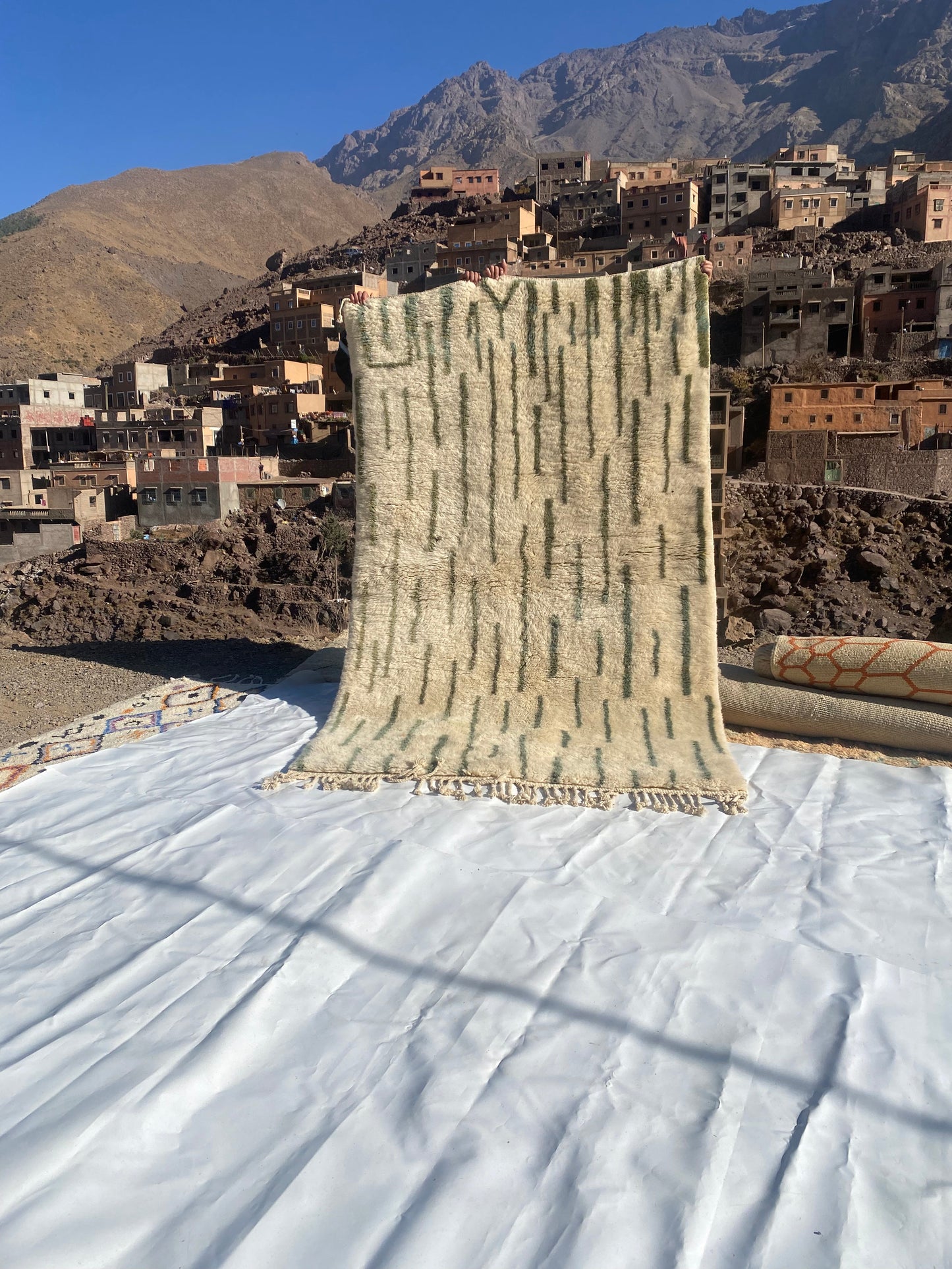 Beni Ourain rugs originate from the Atlas Mountains of Morocco and are characterized by their distinctive, neutral-toned, and geometric designs. These handwoven rugs often feature a plush pile and are made by the Berber tribes, size is 255x155 cm