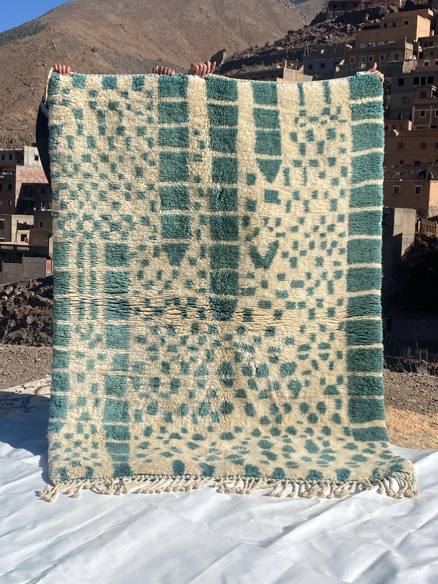 Beni Ourain rugs originate from the Atlas Mountains of Morocco and are characterized by their distinctive, neutral-toned, and geometric designs. These handwoven rugs often feature a plush pile and are made by the Berber tribes, size is 215x160 cm