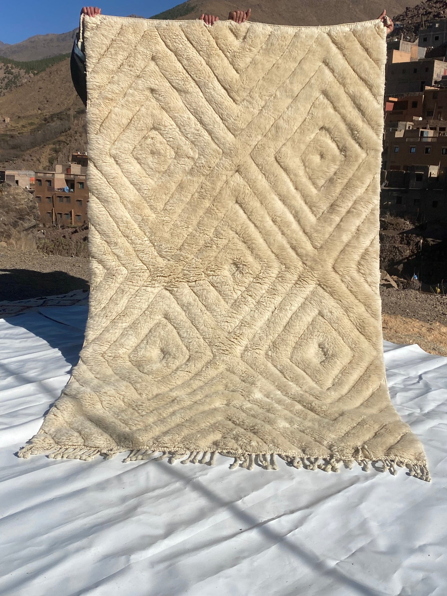 Beni Ourain rugs originate from the Atlas Mountains of Morocco and are characterized by their distinctive, neutral-toned, and geometric designs. These handwoven rugs often feature a plush pile and are made by the Berber tribes, size is 260x150 cm