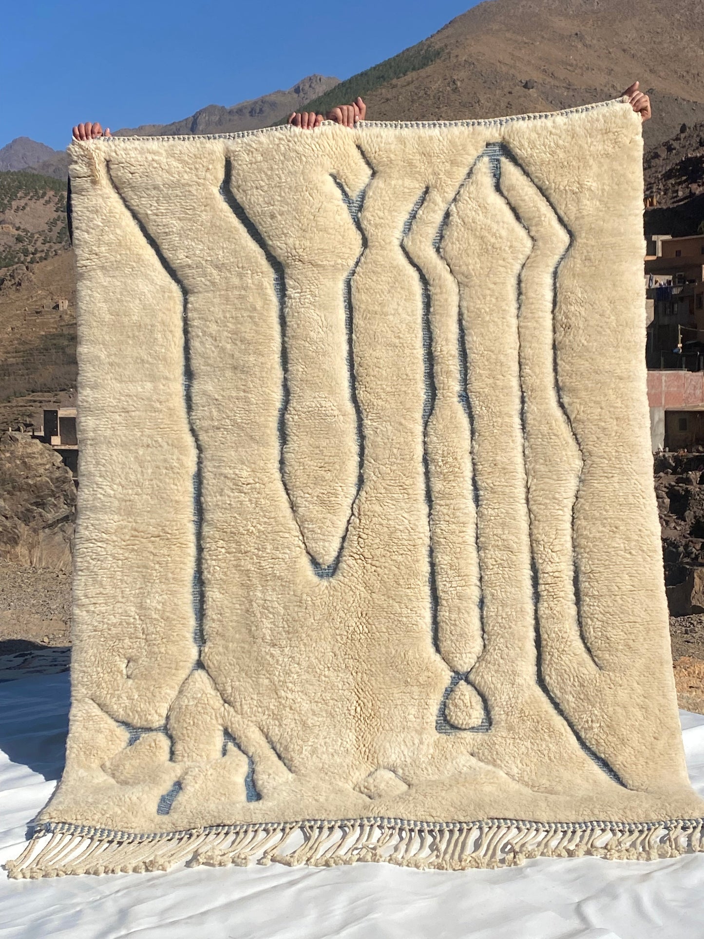 Beni Ourain rugs originate from the Atlas Mountains of Morocco and are characterized by their distinctive, neutral-toned, and geometric designs. These handwoven rugs often feature a plush pile and are made by the Berber tribes, size is 215x160 cm