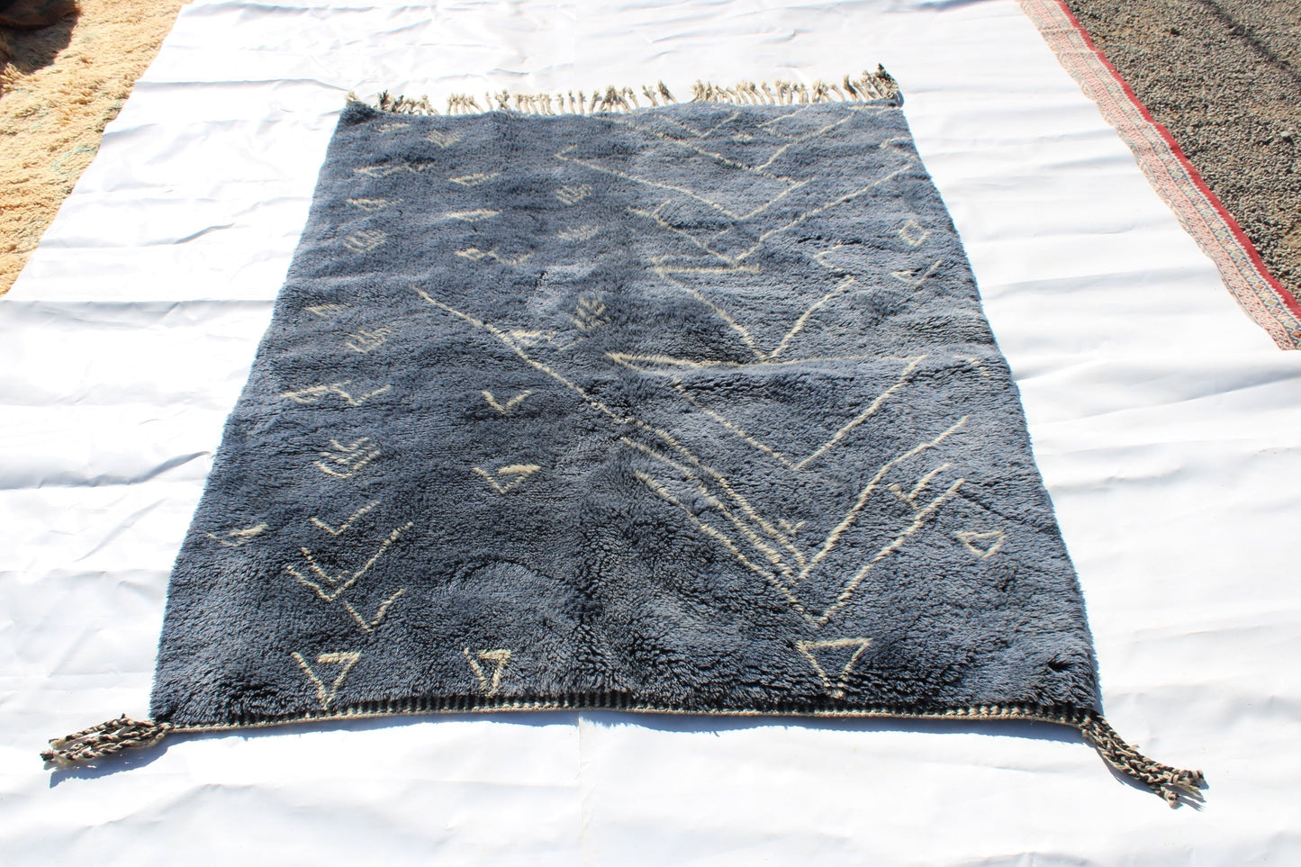 Beni Ourain rugs originate from the Atlas Mountains of Morocco and are characterized by their distinctive, neutral-toned, and geometric designs. These handwoven rugs often feature a plush pile and are made by the Berber tribes, size is 210x160 cm