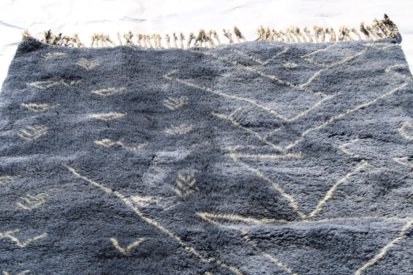 Beni Ourain rugs originate from the Atlas Mountains of Morocco and are characterized by their distinctive, neutral-toned, and geometric designs. These handwoven rugs often feature a plush pile and are made by the Berber tribes, size is 210x160 cm