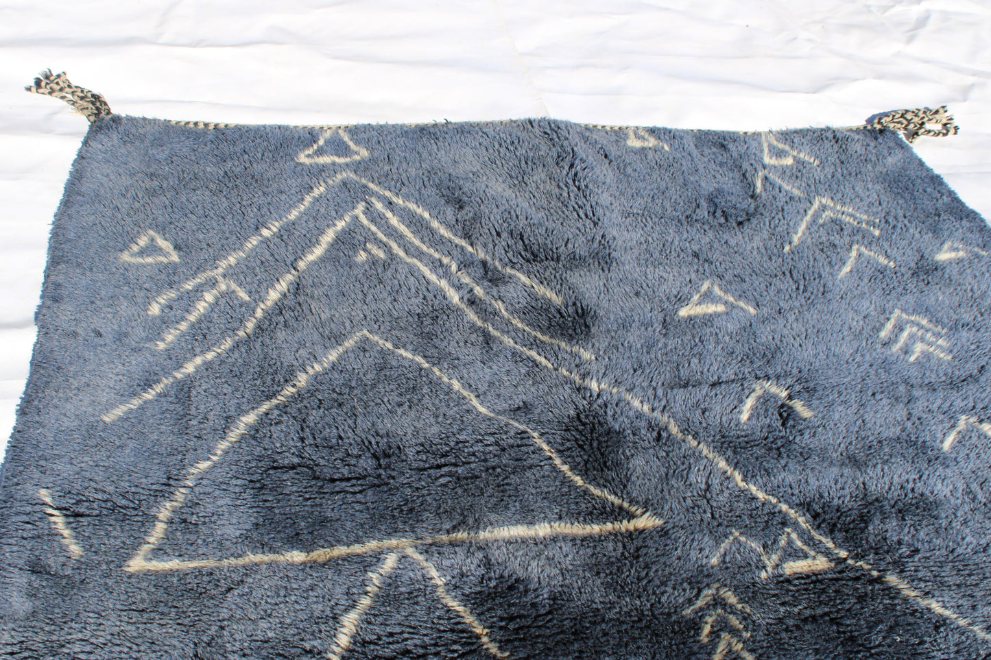 Beni Ourain rugs originate from the Atlas Mountains of Morocco and are characterized by their distinctive, neutral-toned, and geometric designs. These handwoven rugs often feature a plush pile and are made by the Berber tribes, size is 210x160 cm