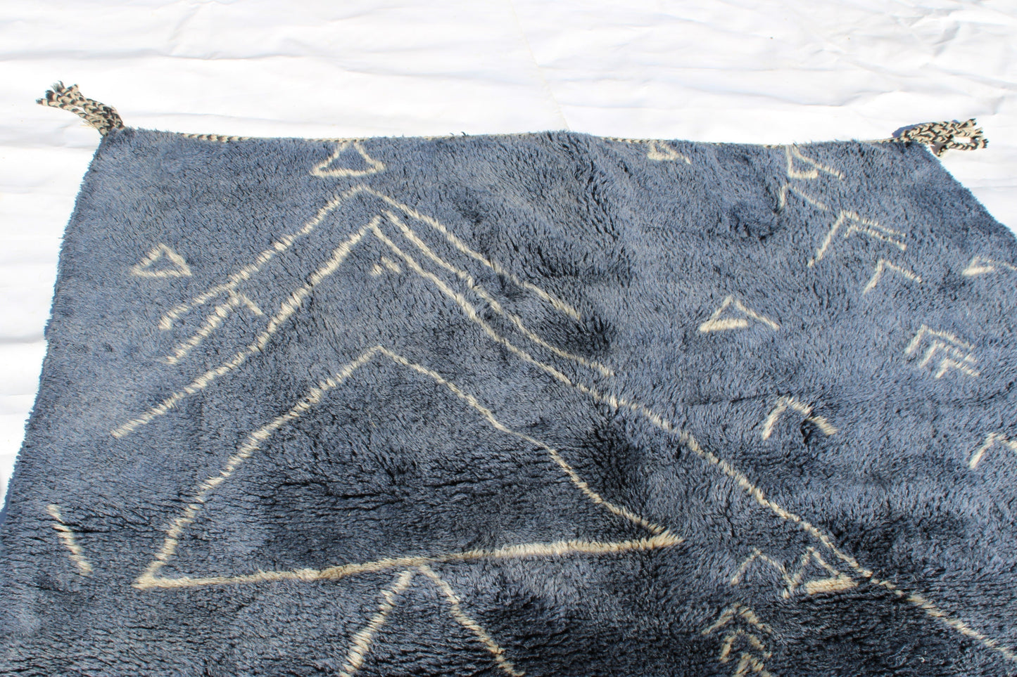 Beni Ourain rugs originate from the Atlas Mountains of Morocco and are characterized by their distinctive, neutral-toned, and geometric designs. These handwoven rugs often feature a plush pile and are made by the Berber tribes, size is 210x160 cm