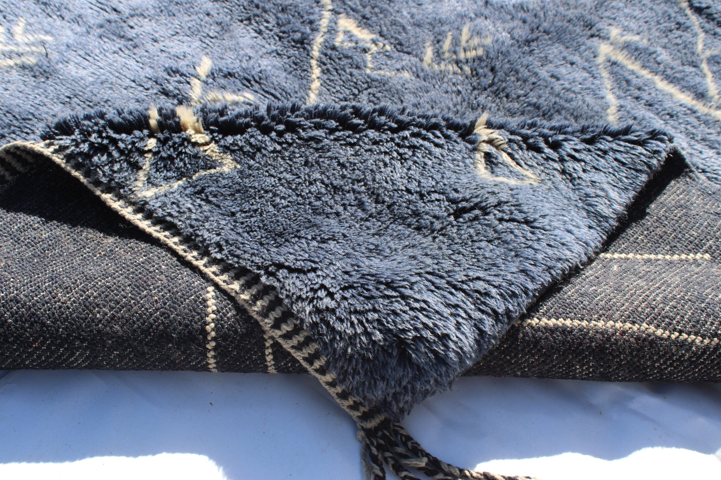 Beni Ourain rugs originate from the Atlas Mountains of Morocco and are characterized by their distinctive, neutral-toned, and geometric designs. These handwoven rugs often feature a plush pile and are made by the Berber tribes, size is 210x160 cm