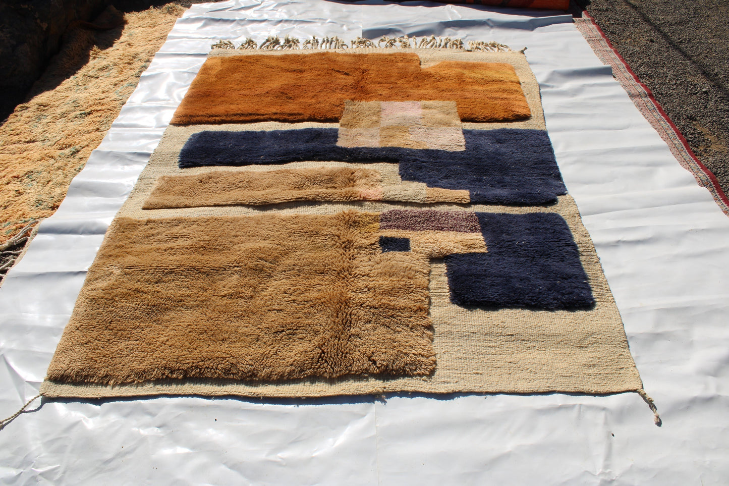 Beni Ourain rugs originate from the Atlas Mountains of Morocco and are characterized by their distinctive, neutral-toned, and geometric designs. These handwoven rugs often feature a plush pile and are made by the Berber tribes, size is 260x165 cm