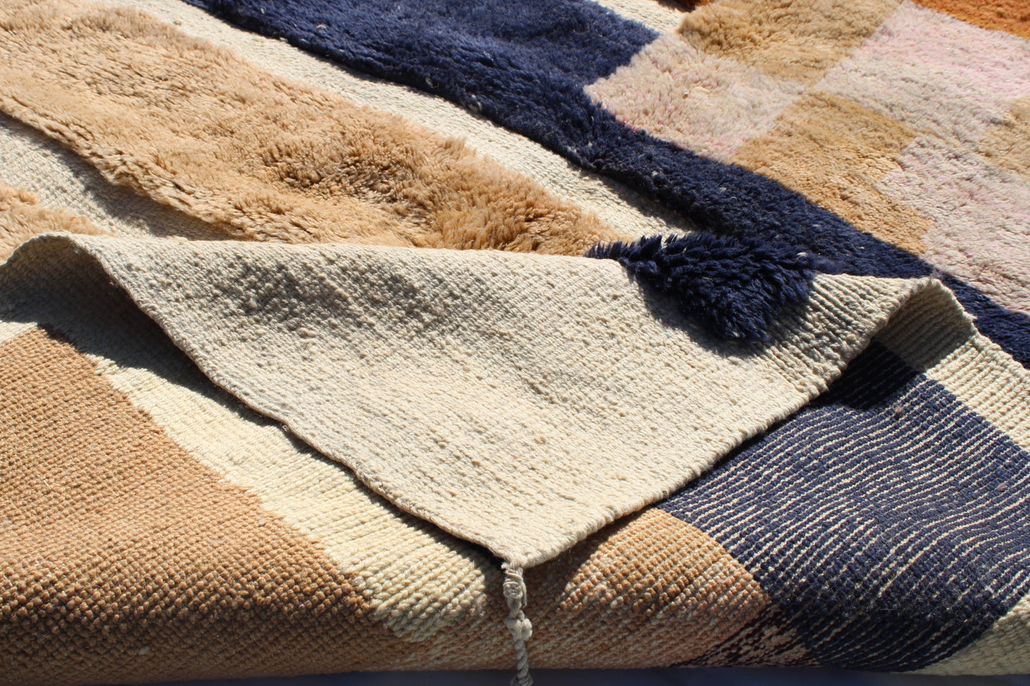 Beni Ourain rugs originate from the Atlas Mountains of Morocco and are characterized by their distinctive, neutral-toned, and geometric designs. These handwoven rugs often feature a plush pile and are made by the Berber tribes, size is 260x165 cm