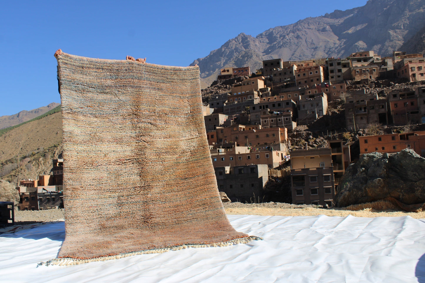 Beni Ourain rugs originate from the Atlas Mountains of Morocco and are characterized by their distinctive, neutral-toned, and geometric designs. These handwoven rugs often feature a plush pile and are made by the Berber tribes, size is 250x155 cm