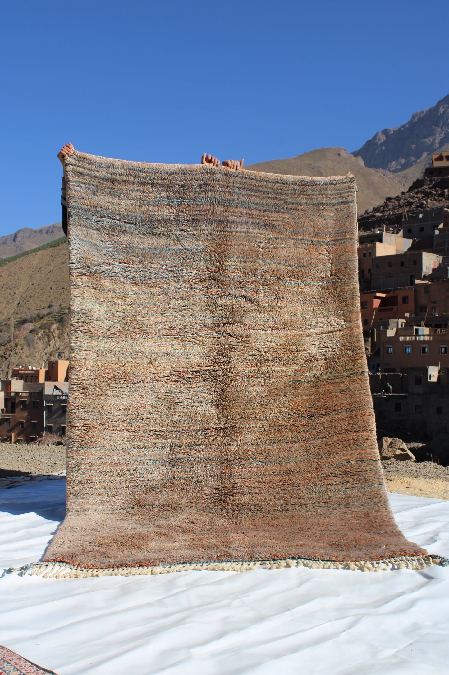 Beni Ourain rugs originate from the Atlas Mountains of Morocco and are characterized by their distinctive, neutral-toned, and geometric designs. These handwoven rugs often feature a plush pile and are made by the Berber tribes, size is 250x155 cm