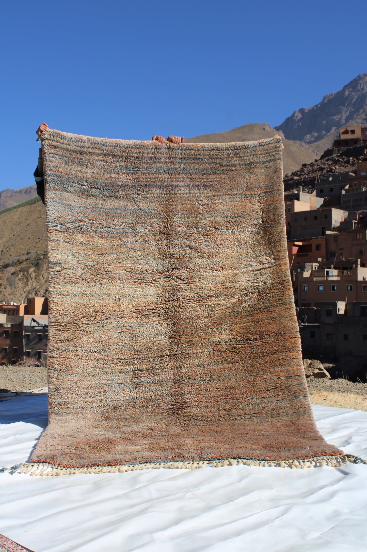 Beni Ourain rugs originate from the Atlas Mountains of Morocco and are characterized by their distinctive, neutral-toned, and geometric designs. These handwoven rugs often feature a plush pile and are made by the Berber tribes, size is 250x155 cm