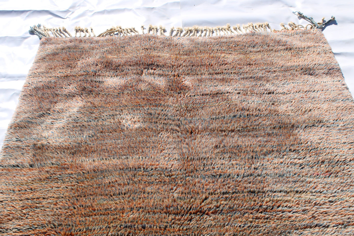 Beni Ourain rugs originate from the Atlas Mountains of Morocco and are characterized by their distinctive, neutral-toned, and geometric designs. These handwoven rugs often feature a plush pile and are made by the Berber tribes, size is 250x155 cm