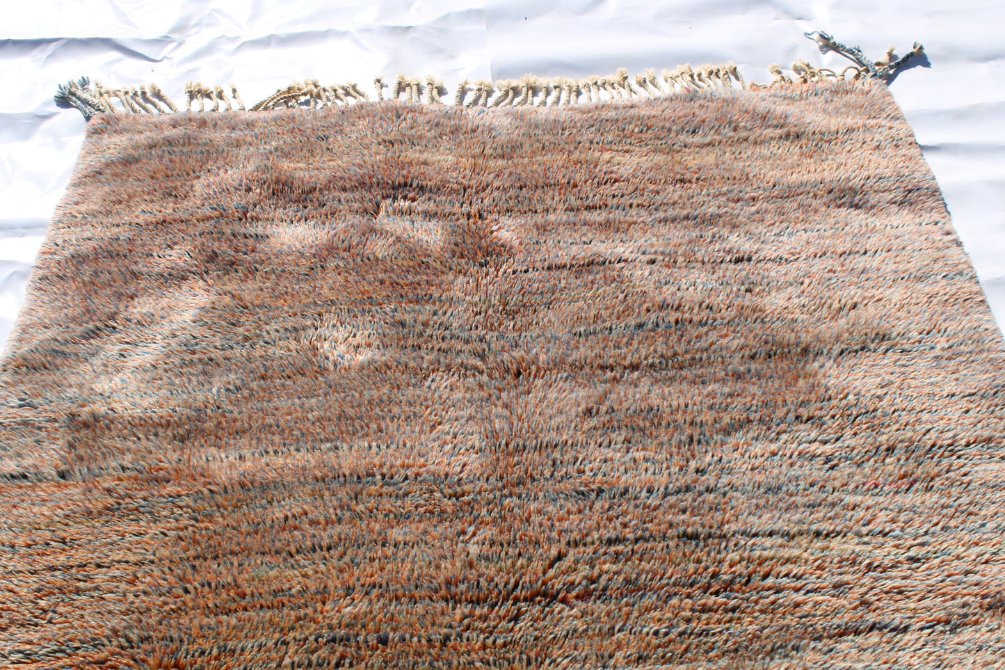 Beni Ourain rugs originate from the Atlas Mountains of Morocco and are characterized by their distinctive, neutral-toned, and geometric designs. These handwoven rugs often feature a plush pile and are made by the Berber tribes, size is 250x155 cm