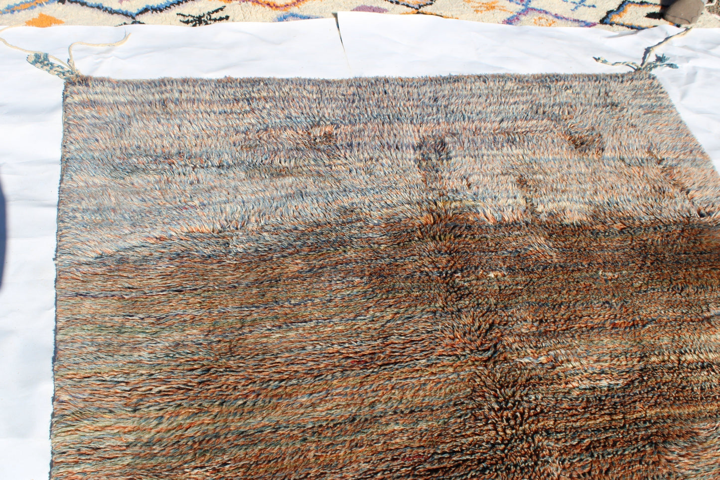 Beni Ourain rugs originate from the Atlas Mountains of Morocco and are characterized by their distinctive, neutral-toned, and geometric designs. These handwoven rugs often feature a plush pile and are made by the Berber tribes, size is 250x155 cm