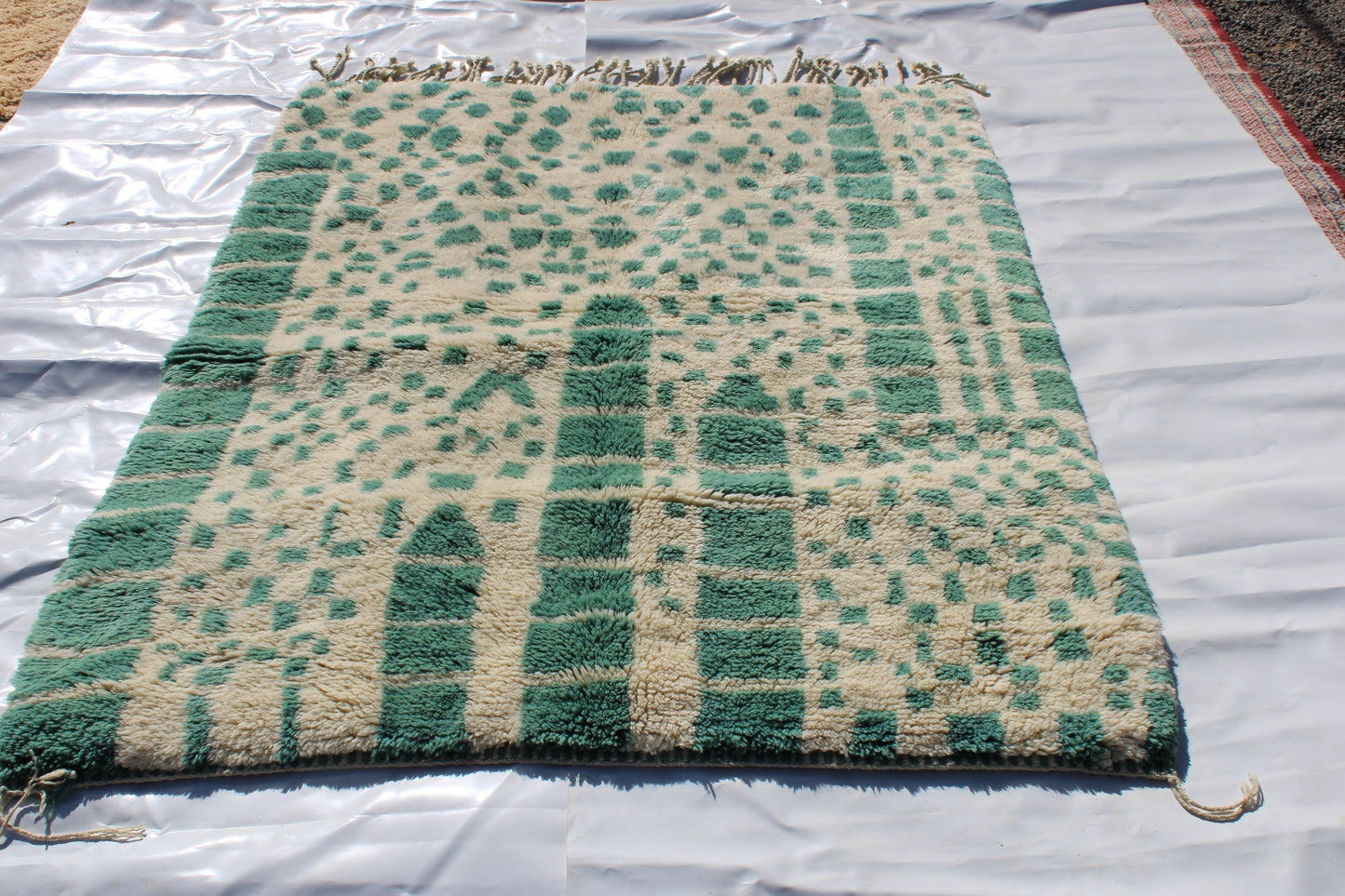 Beni Ourain rugs originate from the Atlas Mountains of Morocco and are characterized by their distinctive, neutral-toned, and geometric designs. These handwoven rugs often feature a plush pile and are made by the Berber tribes, size is 215x160 cm