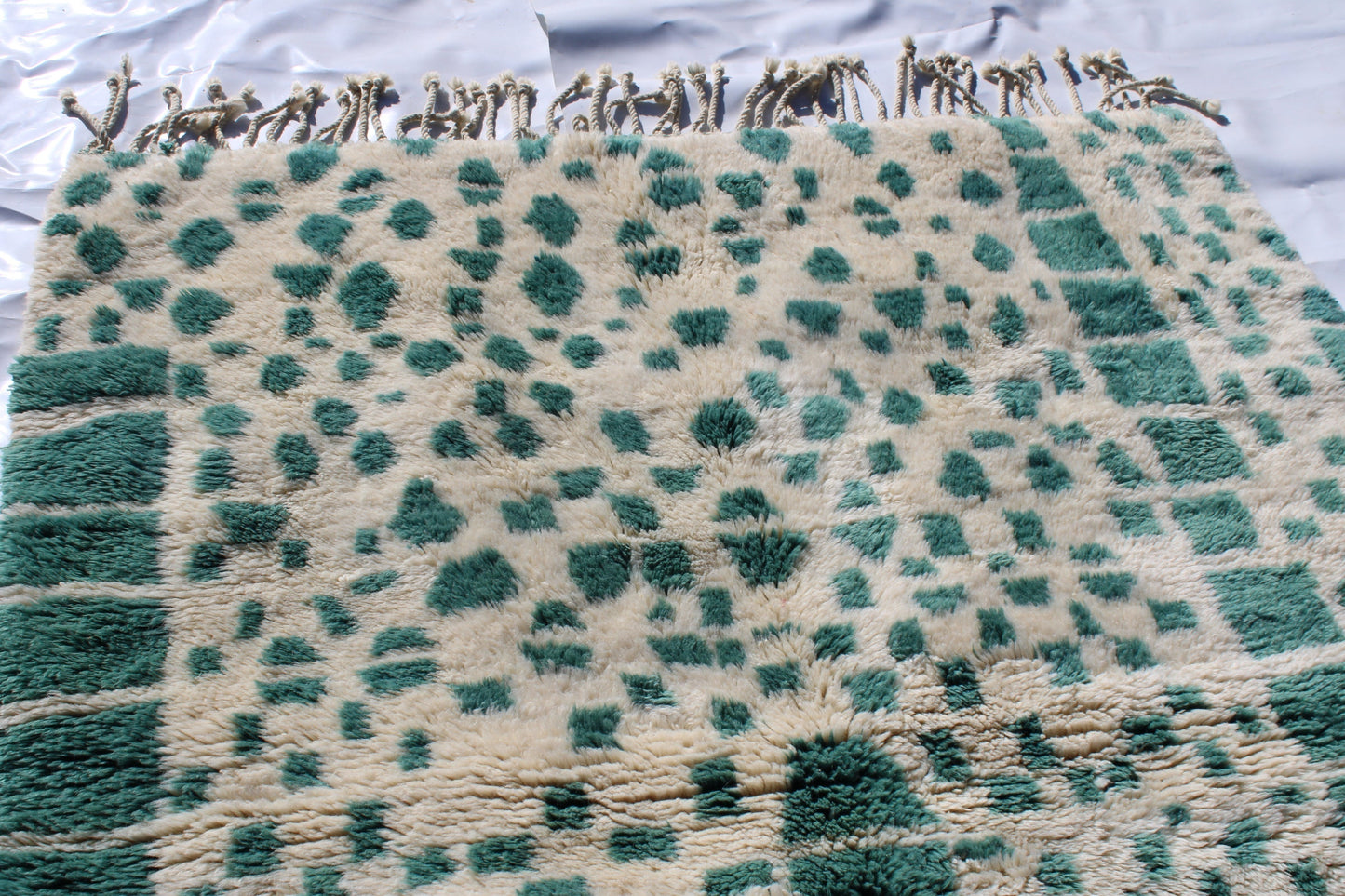 Beni Ourain rugs originate from the Atlas Mountains of Morocco and are characterized by their distinctive, neutral-toned, and geometric designs. These handwoven rugs often feature a plush pile and are made by the Berber tribes, size is 215x160 cm