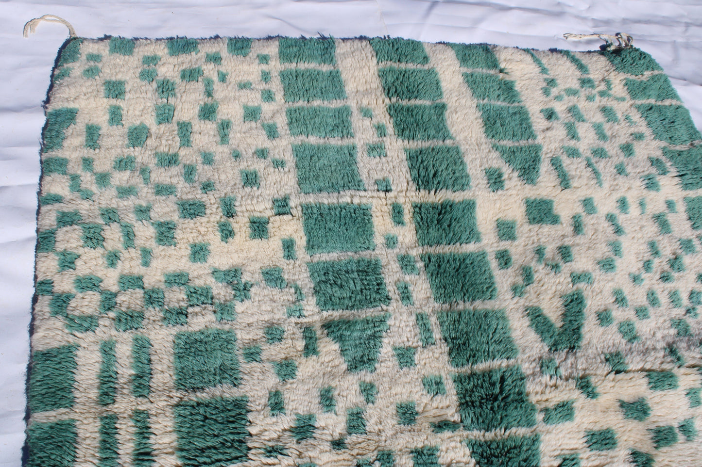 Beni Ourain rugs originate from the Atlas Mountains of Morocco and are characterized by their distinctive, neutral-toned, and geometric designs. These handwoven rugs often feature a plush pile and are made by the Berber tribes, size is 215x160 cm