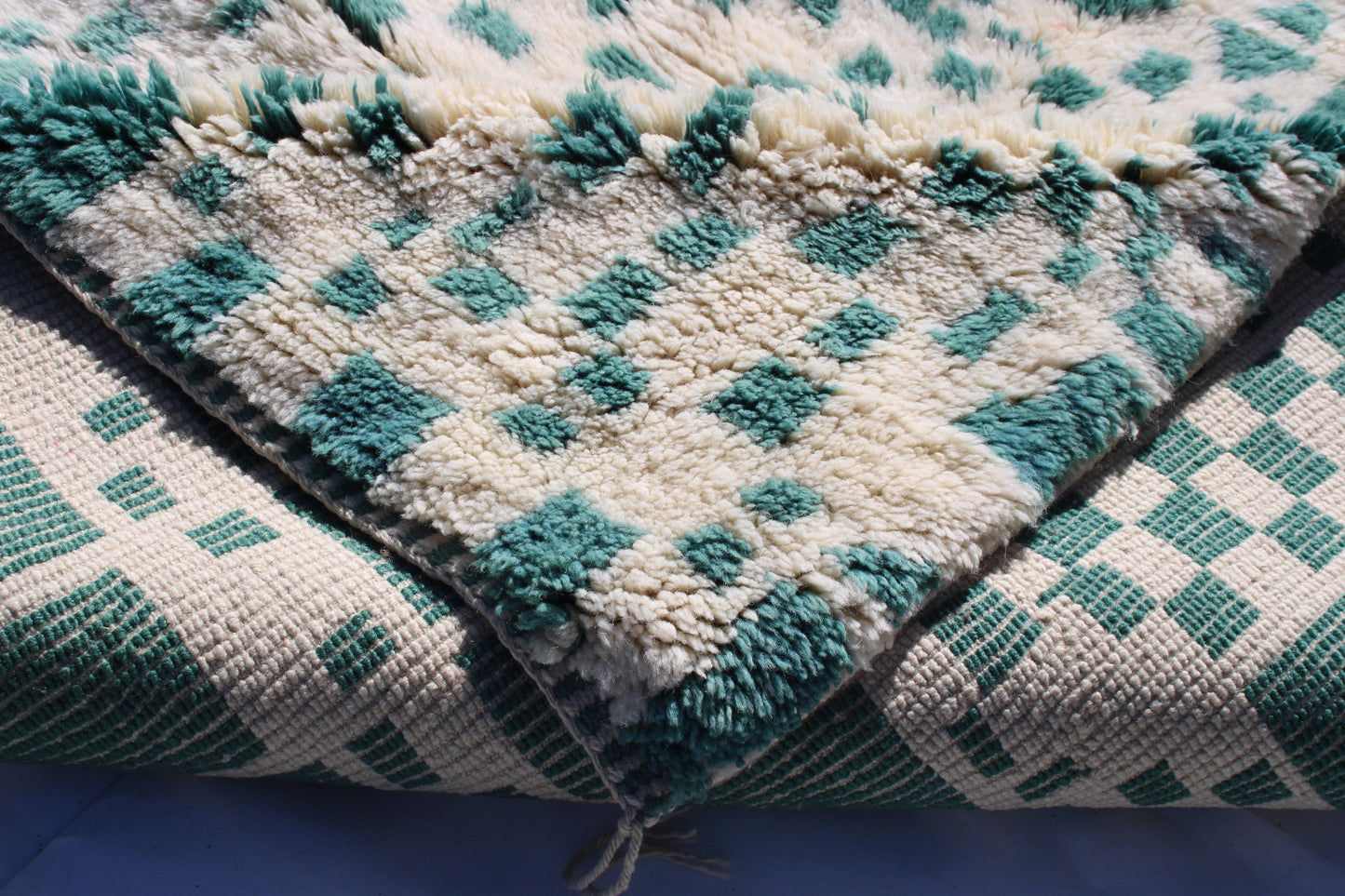 Beni Ourain rugs originate from the Atlas Mountains of Morocco and are characterized by their distinctive, neutral-toned, and geometric designs. These handwoven rugs often feature a plush pile and are made by the Berber tribes, size is 215x160 cm