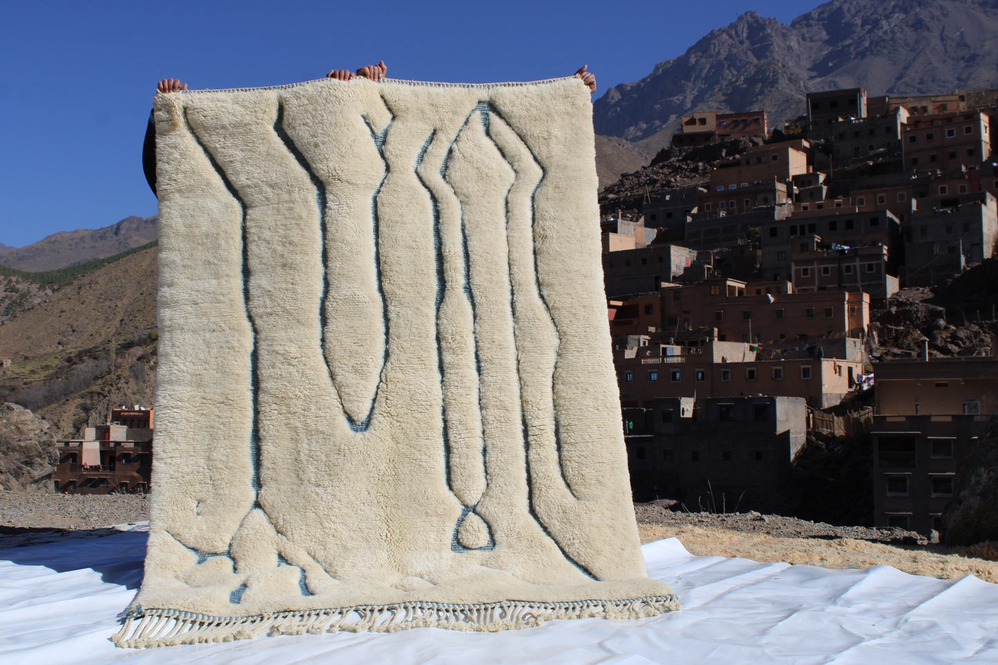 Beni Ourain rugs originate from the Atlas Mountains of Morocco and are characterized by their distinctive, neutral-toned, and geometric designs. These handwoven rugs often feature a plush pile and are made by the Berber tribes, size is 215x160 cm