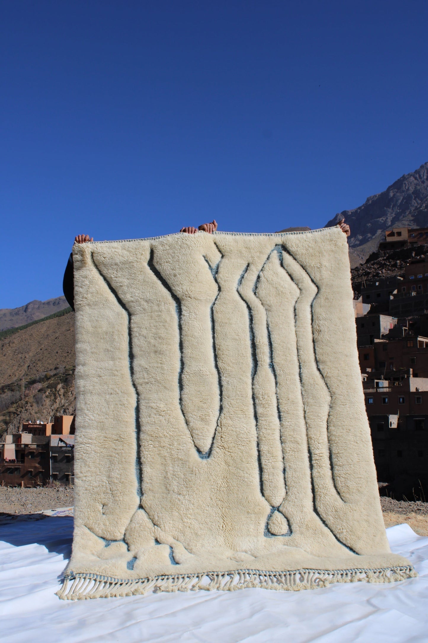 Beni Ourain rugs originate from the Atlas Mountains of Morocco and are characterized by their distinctive, neutral-toned, and geometric designs. These handwoven rugs often feature a plush pile and are made by the Berber tribes, size is 215x160 cm