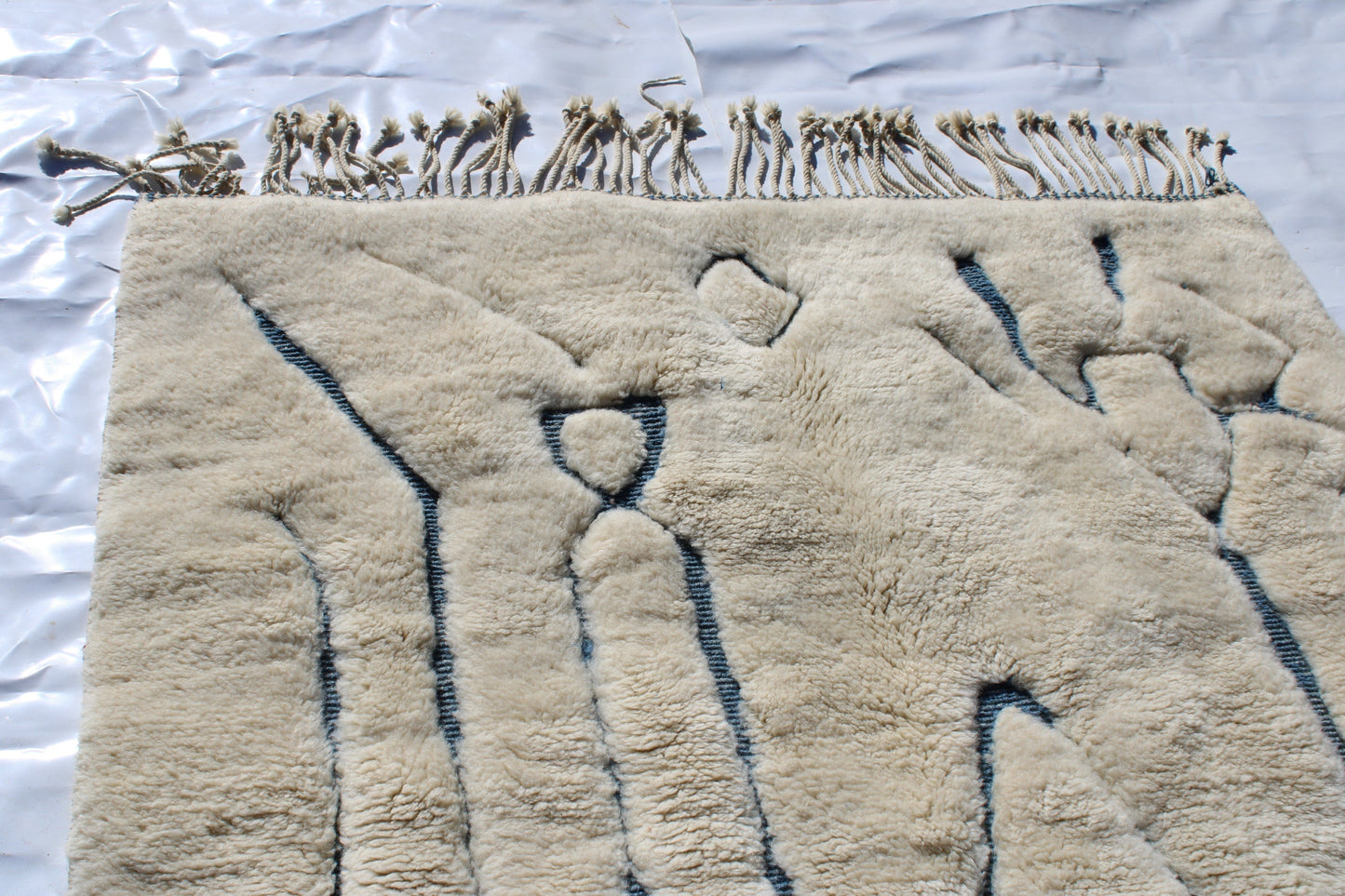 Beni Ourain rugs originate from the Atlas Mountains of Morocco and are characterized by their distinctive, neutral-toned, and geometric designs. These handwoven rugs often feature a plush pile and are made by the Berber tribes, size is 215x160 cm