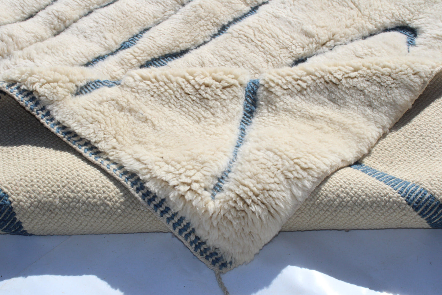 Beni Ourain rugs originate from the Atlas Mountains of Morocco and are characterized by their distinctive, neutral-toned, and geometric designs. These handwoven rugs often feature a plush pile and are made by the Berber tribes, size is 215x160 cm