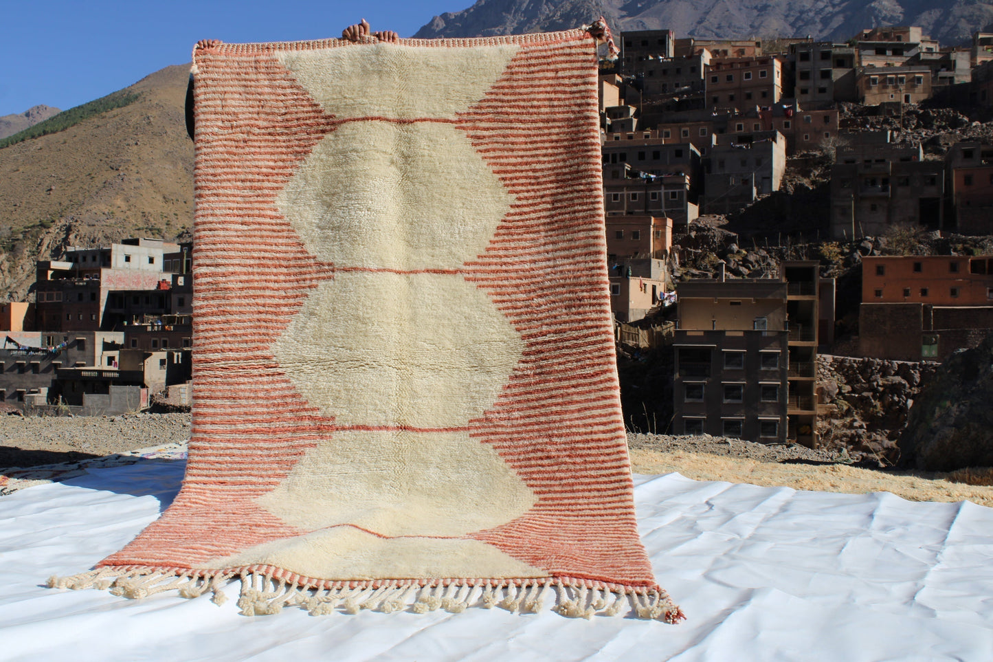 Beni Ourain rugs originate from the Atlas Mountains of Morocco and are characterized by their distinctive, neutral-toned, and geometric designs. These handwoven rugs often feature a plush pile and are made by the Berber tribes, size is 255x150 cm