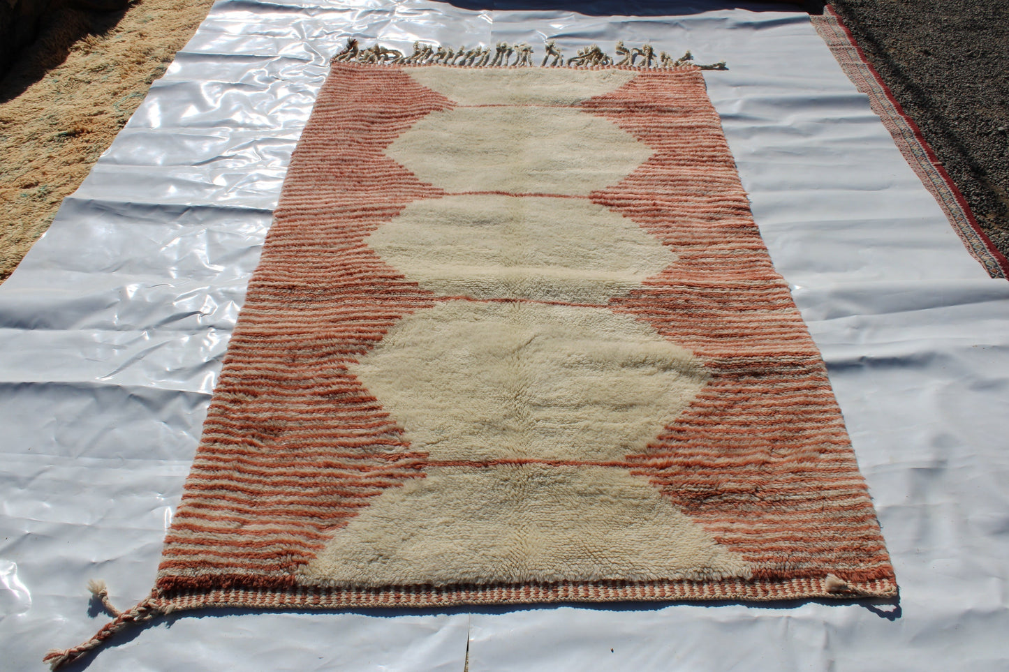 Beni Ourain rugs originate from the Atlas Mountains of Morocco and are characterized by their distinctive, neutral-toned, and geometric designs. These handwoven rugs often feature a plush pile and are made by the Berber tribes, size is 255x150 cm