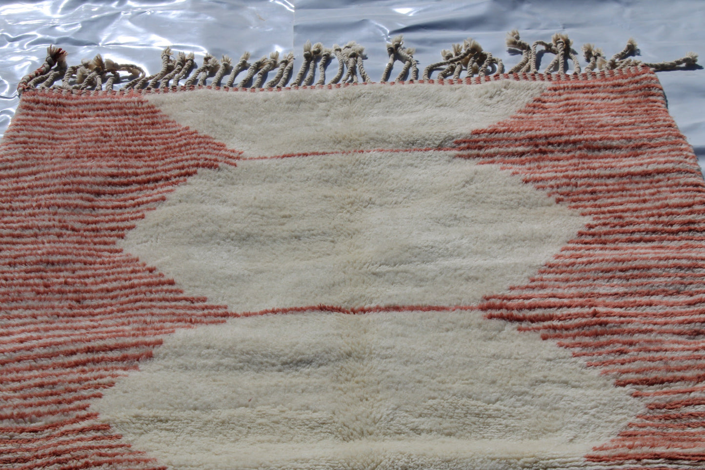 Beni Ourain rugs originate from the Atlas Mountains of Morocco and are characterized by their distinctive, neutral-toned, and geometric designs. These handwoven rugs often feature a plush pile and are made by the Berber tribes, size is 255x150 cm