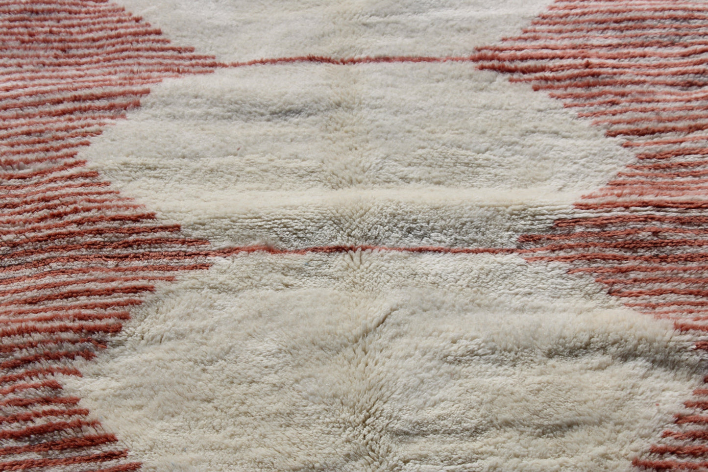 Beni Ourain rugs originate from the Atlas Mountains of Morocco and are characterized by their distinctive, neutral-toned, and geometric designs. These handwoven rugs often feature a plush pile and are made by the Berber tribes, size is 255x150 cm