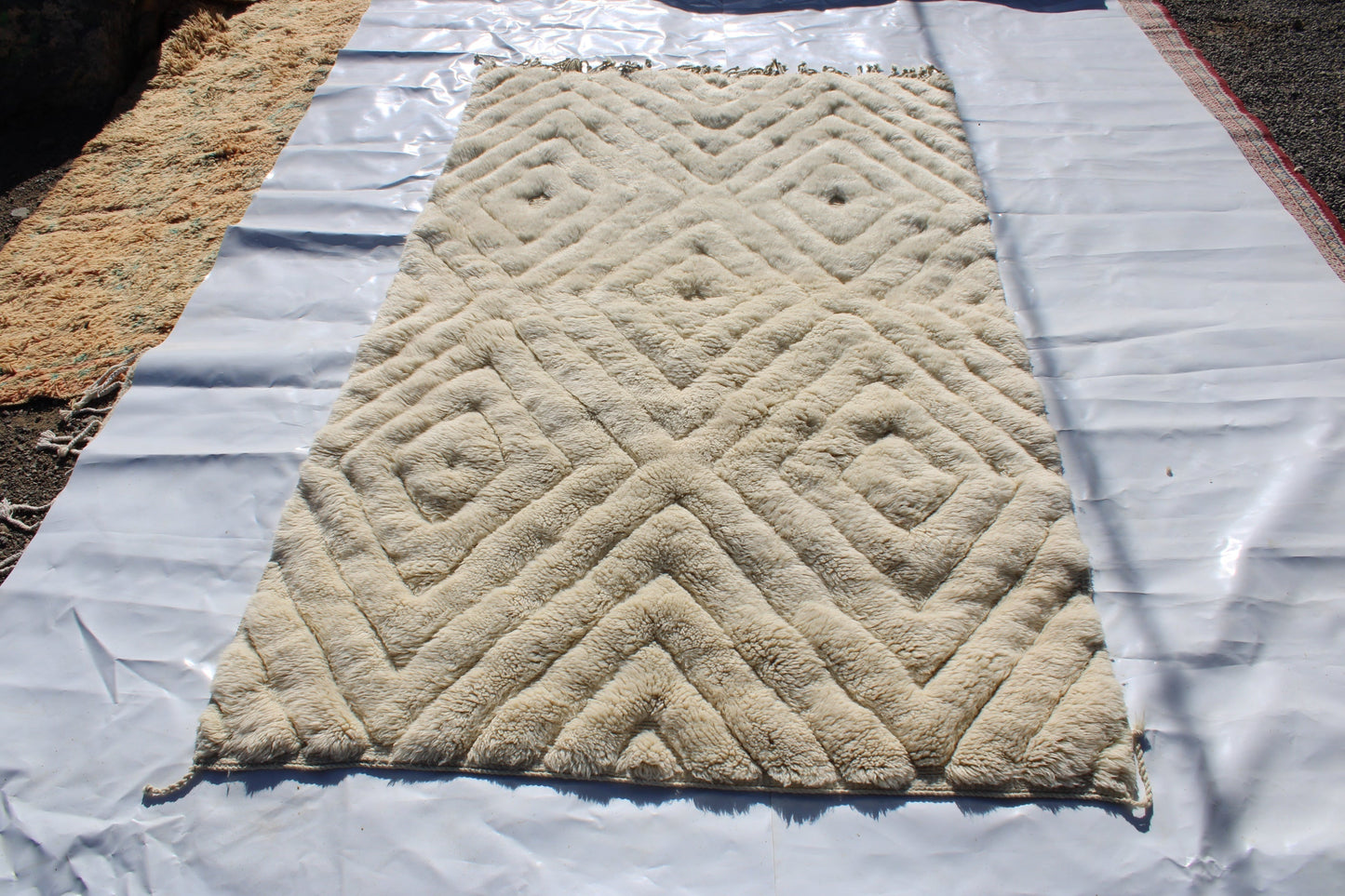 Beni Ourain rugs originate from the Atlas Mountains of Morocco and are characterized by their distinctive, neutral-toned, and geometric designs. These handwoven rugs often feature a plush pile and are made by the Berber tribes, size is 260x150 cm