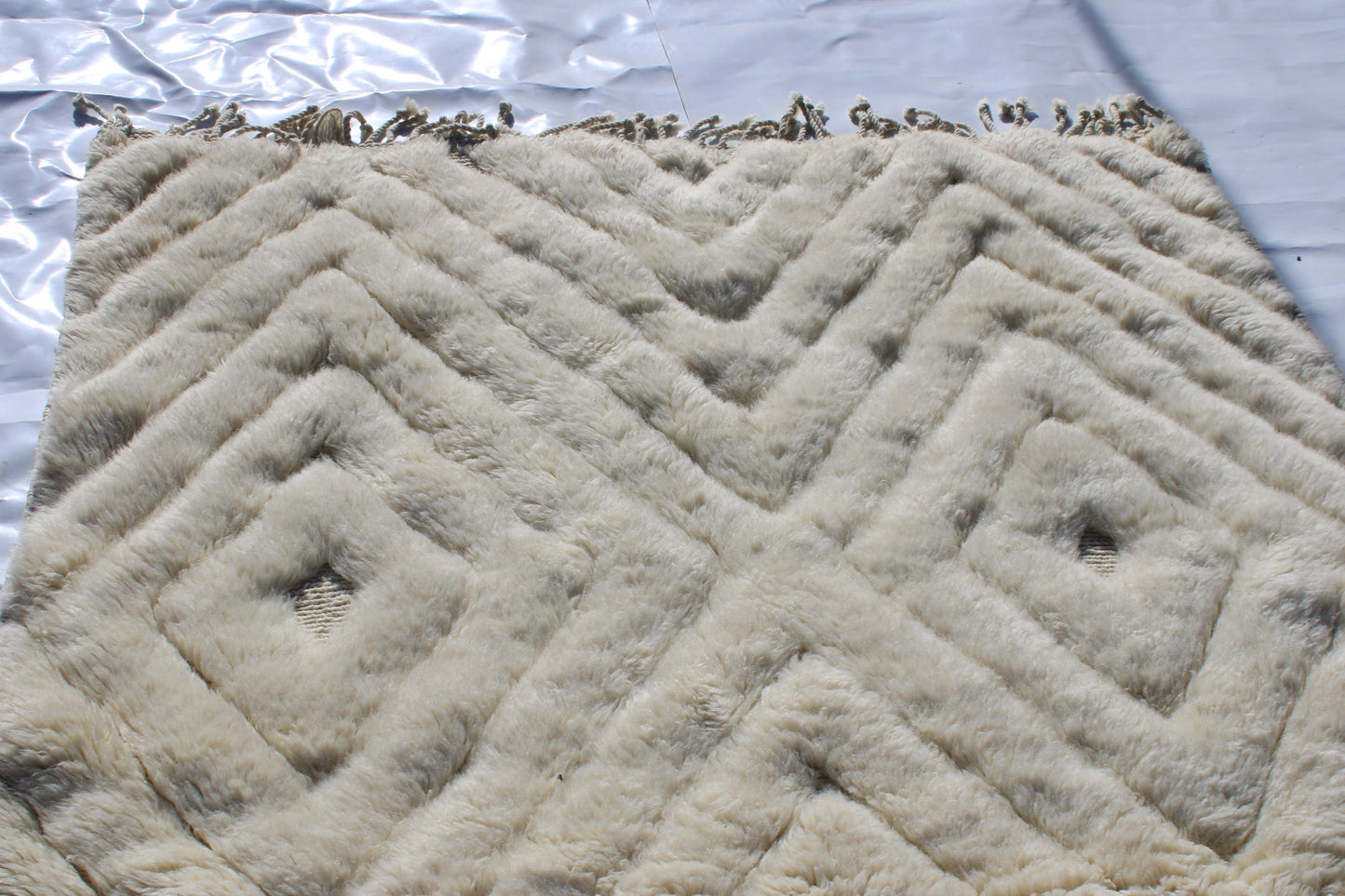 Beni Ourain rugs originate from the Atlas Mountains of Morocco and are characterized by their distinctive, neutral-toned, and geometric designs. These handwoven rugs often feature a plush pile and are made by the Berber tribes, size is 260x150 cm