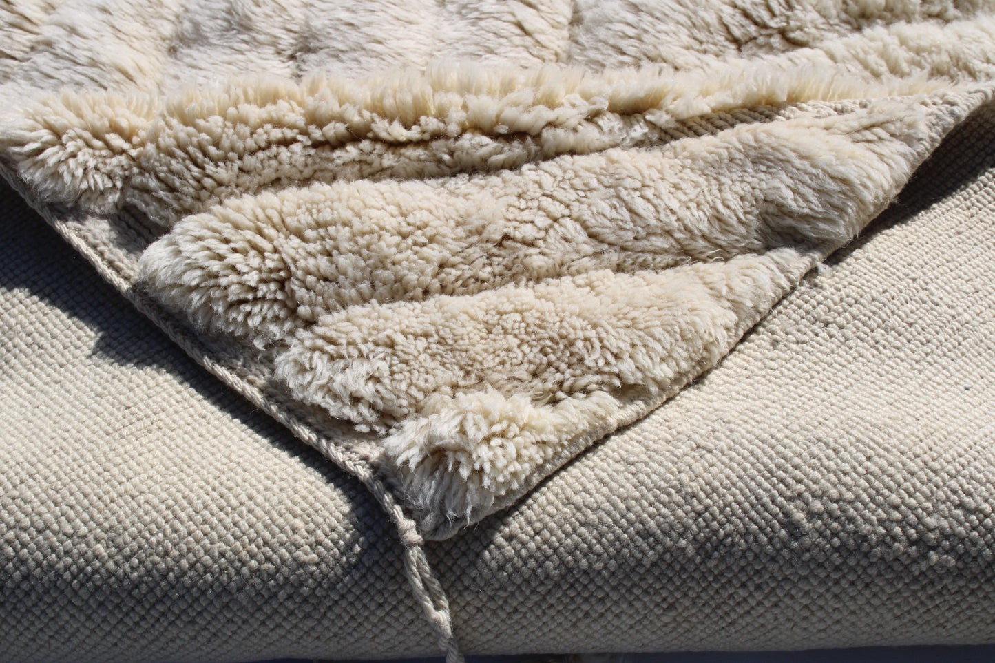 Beni Ourain rugs originate from the Atlas Mountains of Morocco and are characterized by their distinctive, neutral-toned, and geometric designs. These handwoven rugs often feature a plush pile and are made by the Berber tribes, size is 260x150 cm