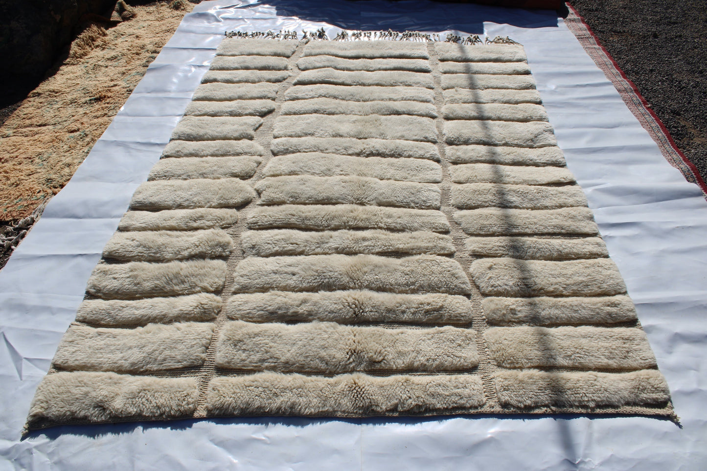 Beni Ourain rugs originate from the Atlas Mountains of Morocco and are characterized by their distinctive, neutral-toned, and geometric designs. These handwoven rugs often feature a plush pile and are made by the Berber tribes, size is 285x195 cm