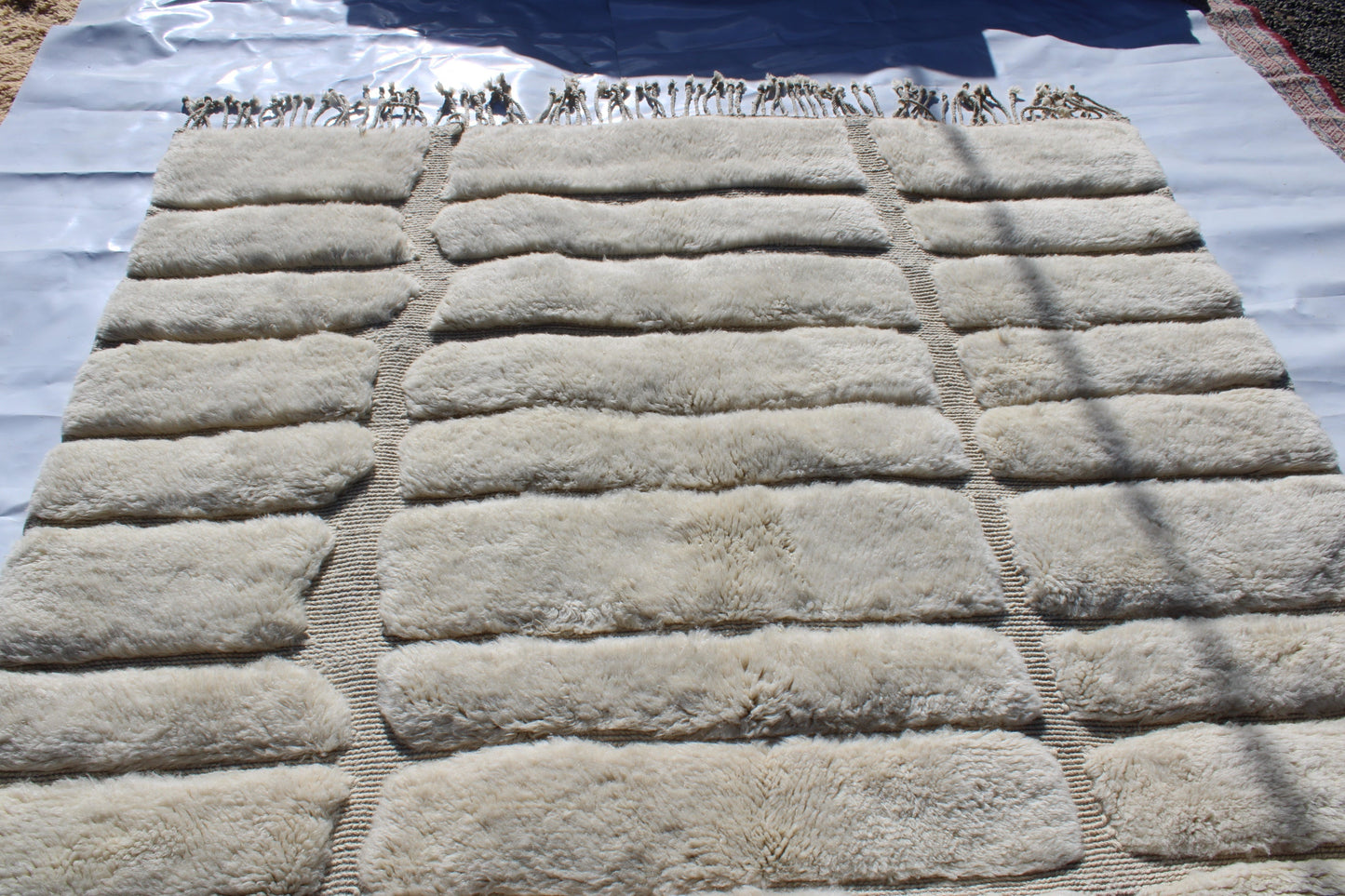 Beni Ourain rugs originate from the Atlas Mountains of Morocco and are characterized by their distinctive, neutral-toned, and geometric designs. These handwoven rugs often feature a plush pile and are made by the Berber tribes, size is 285x195 cm