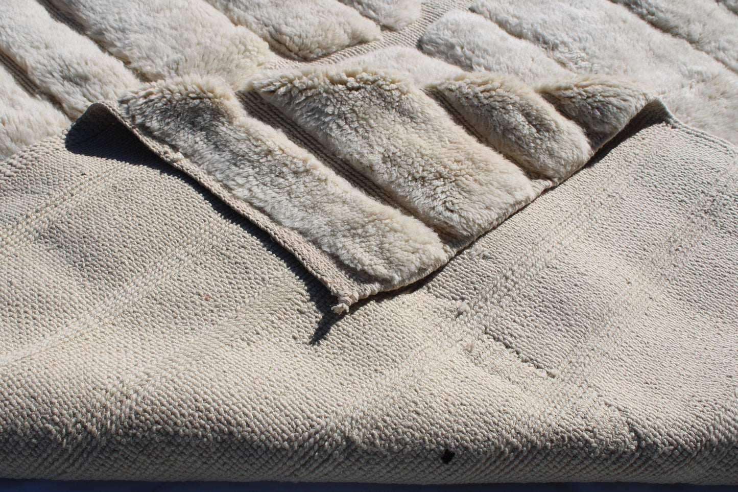 Beni Ourain rugs originate from the Atlas Mountains of Morocco and are characterized by their distinctive, neutral-toned, and geometric designs. These handwoven rugs often feature a plush pile and are made by the Berber tribes, size is 285x195 cm
