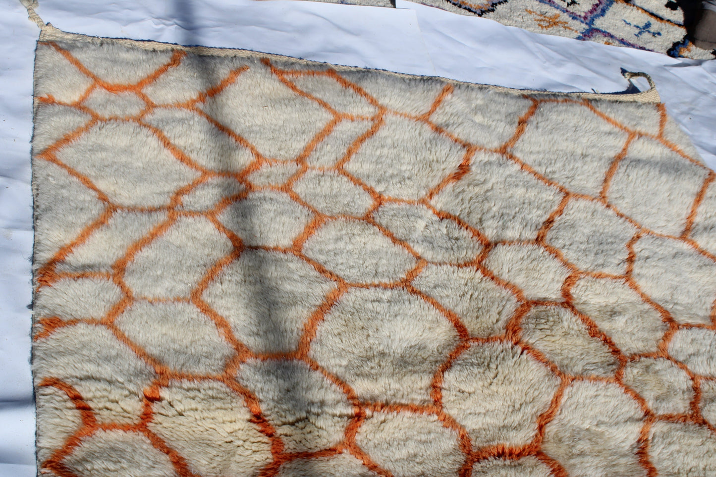 Beni Ourain rugs originate from the Atlas Mountains of Morocco and are characterized by their distinctive, neutral-toned, and geometric designs. These handwoven rugs often feature a plush pile and are made by the Berber tribes, size is 255x155 cm