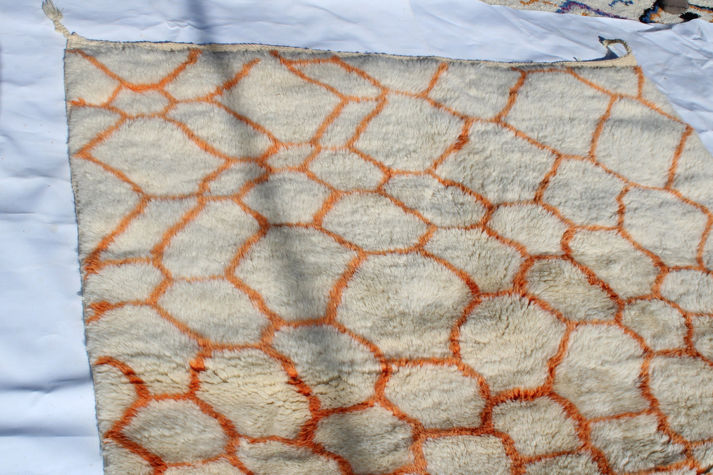 Beni Ourain rugs originate from the Atlas Mountains of Morocco and are characterized by their distinctive, neutral-toned, and geometric designs. These handwoven rugs often feature a plush pile and are made by the Berber tribes, size is 255x155 cm