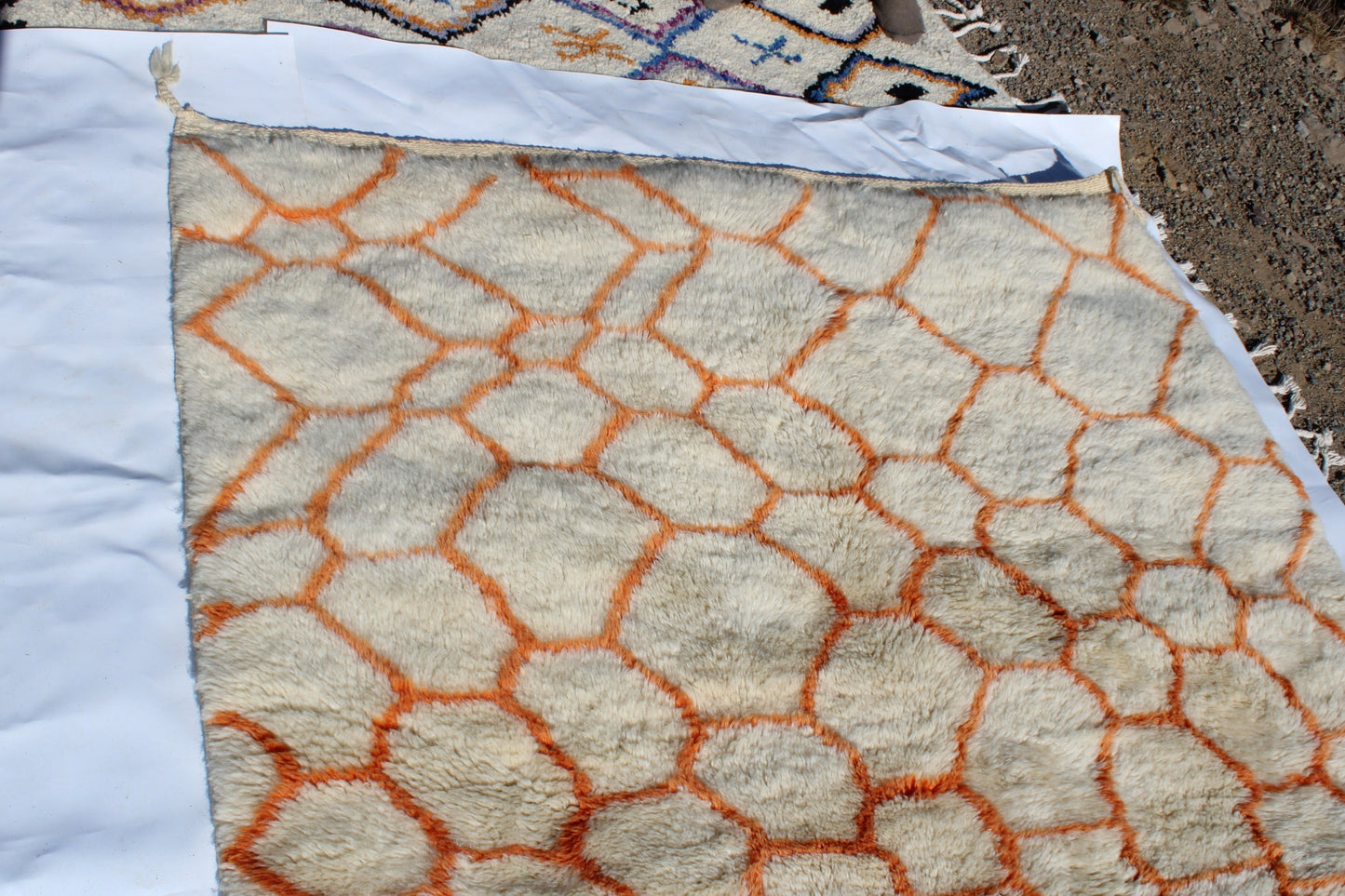 Beni Ourain rugs originate from the Atlas Mountains of Morocco and are characterized by their distinctive, neutral-toned, and geometric designs. These handwoven rugs often feature a plush pile and are made by the Berber tribes, size is 255x155 cm
