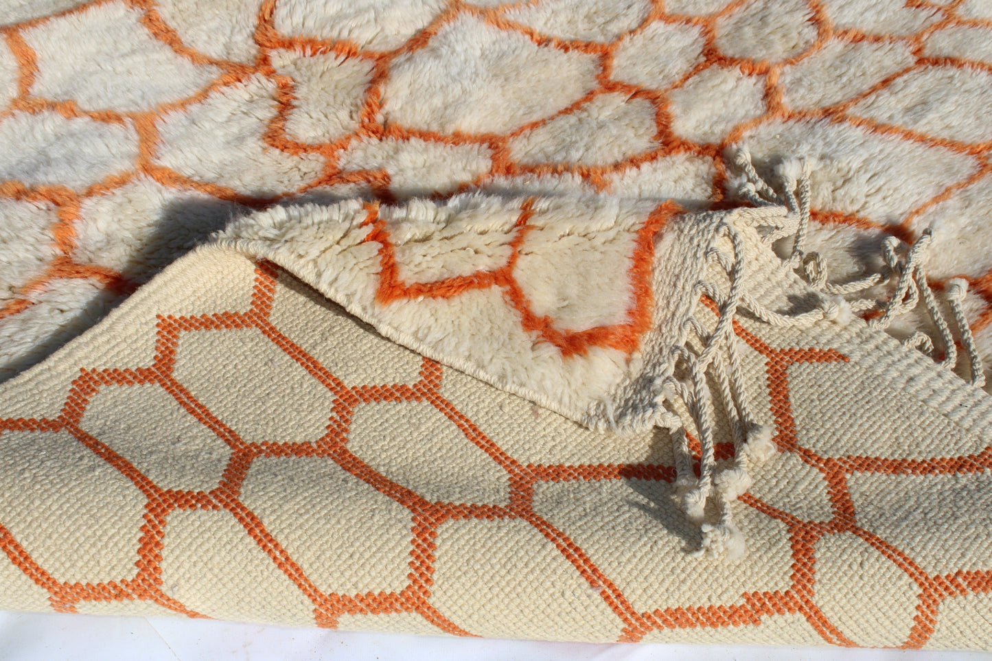 Beni Ourain rugs originate from the Atlas Mountains of Morocco and are characterized by their distinctive, neutral-toned, and geometric designs. These handwoven rugs often feature a plush pile and are made by the Berber tribes, size is 255x155 cm