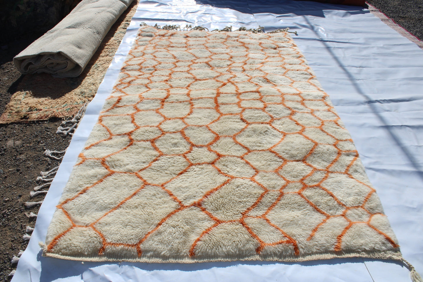 Beni Ourain rugs originate from the Atlas Mountains of Morocco and are characterized by their distinctive, neutral-toned, and geometric designs. These handwoven rugs often feature a plush pile and are made by the Berber tribes, size is 255x155 cm