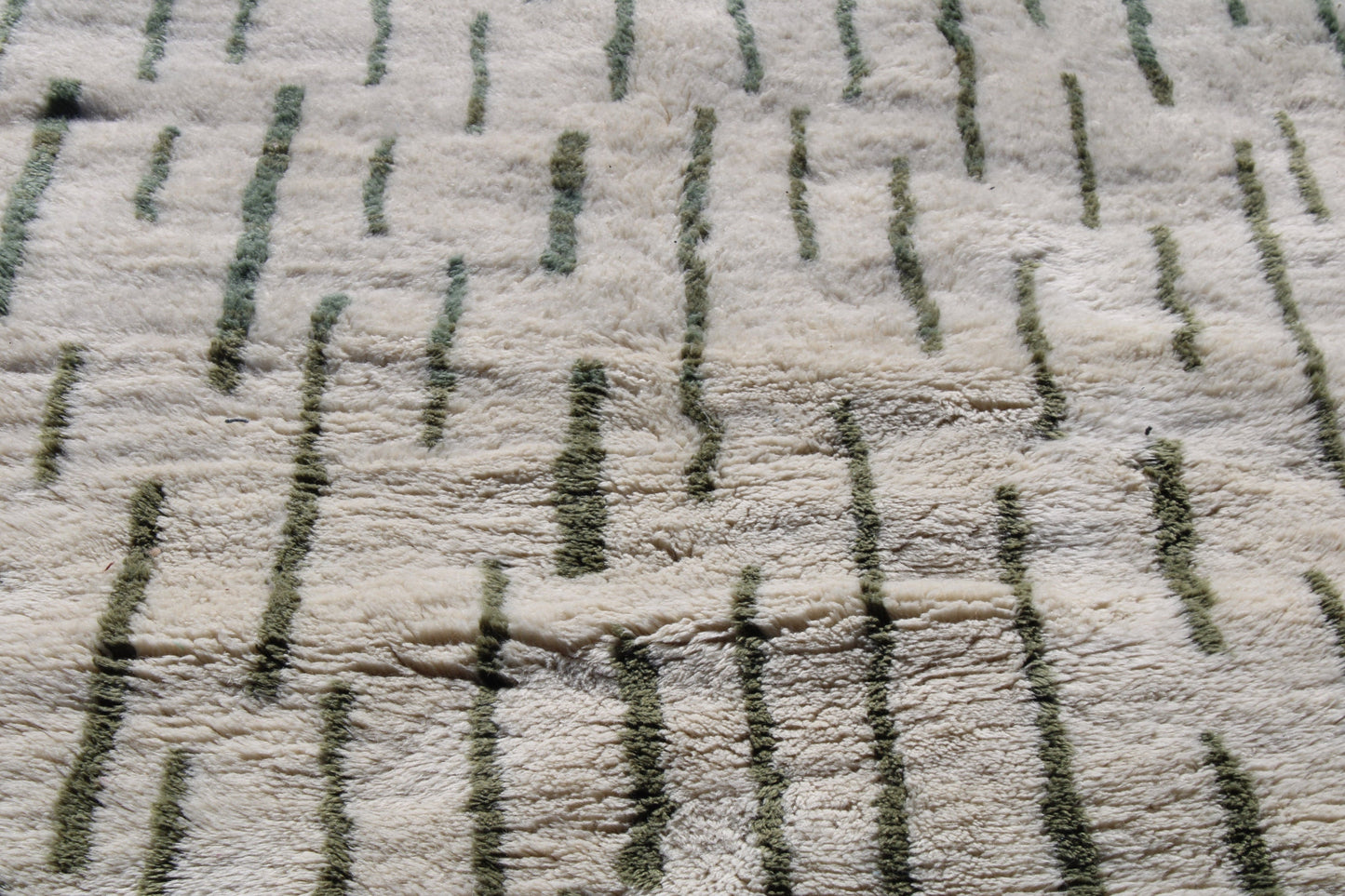Beni Ourain rugs originate from the Atlas Mountains of Morocco and are characterized by their distinctive, neutral-toned, and geometric designs. These handwoven rugs often feature a plush pile and are made by the Berber tribes, size is 255x155 cm