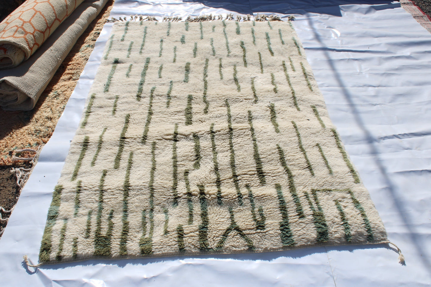 Beni Ourain rugs originate from the Atlas Mountains of Morocco and are characterized by their distinctive, neutral-toned, and geometric designs. These handwoven rugs often feature a plush pile and are made by the Berber tribes, size is 255x155 cm