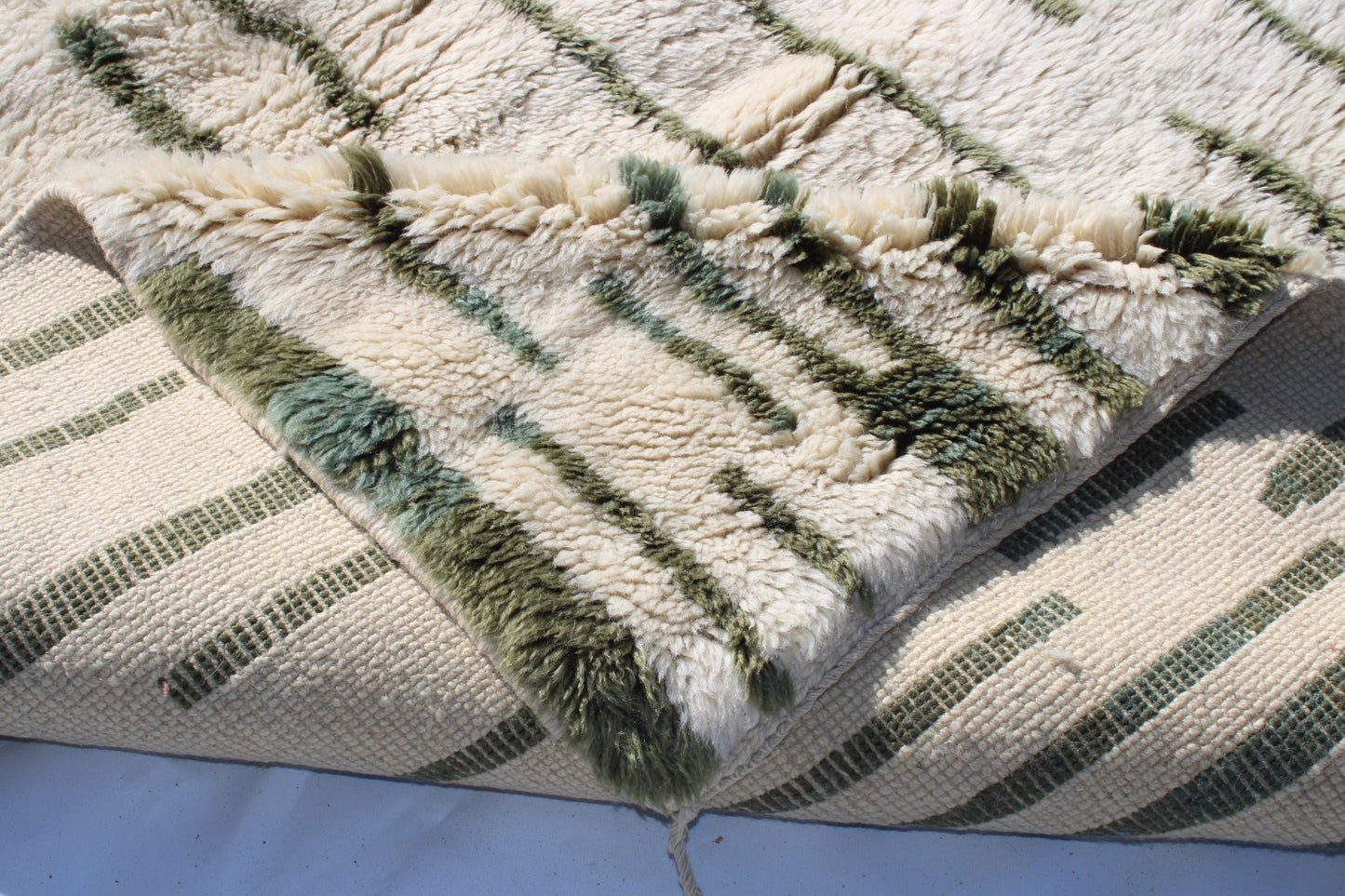 Beni Ourain rugs originate from the Atlas Mountains of Morocco and are characterized by their distinctive, neutral-toned, and geometric designs. These handwoven rugs often feature a plush pile and are made by the Berber tribes, size is 255x155 cm