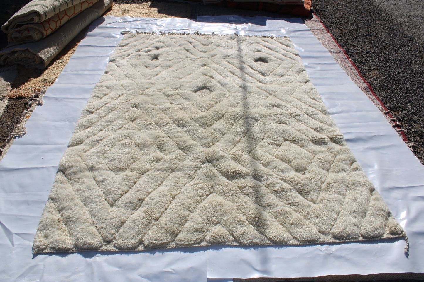 Beni Ourain rugs originate from the Atlas Mountains of Morocco and are characterized by their distinctive, neutral-toned, and geometric designs. These handwoven rugs often feature a plush pile and are made by the Berber tribes, size is 300x200 cm
