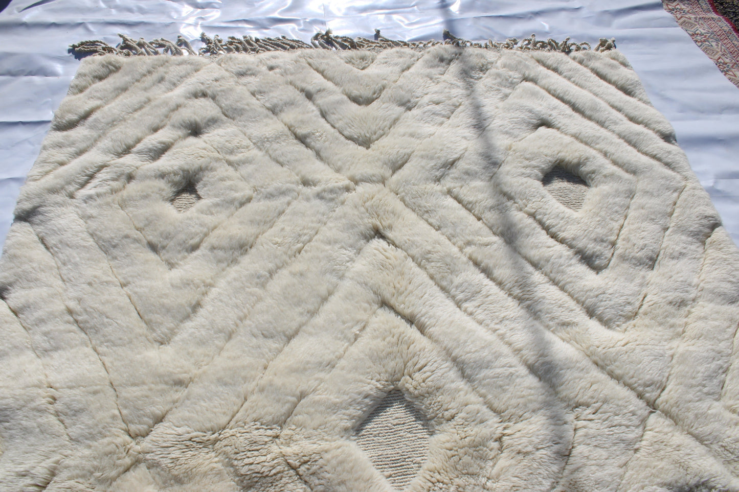 Beni Ourain rugs originate from the Atlas Mountains of Morocco and are characterized by their distinctive, neutral-toned, and geometric designs. These handwoven rugs often feature a plush pile and are made by the Berber tribes, size is 300x200 cm