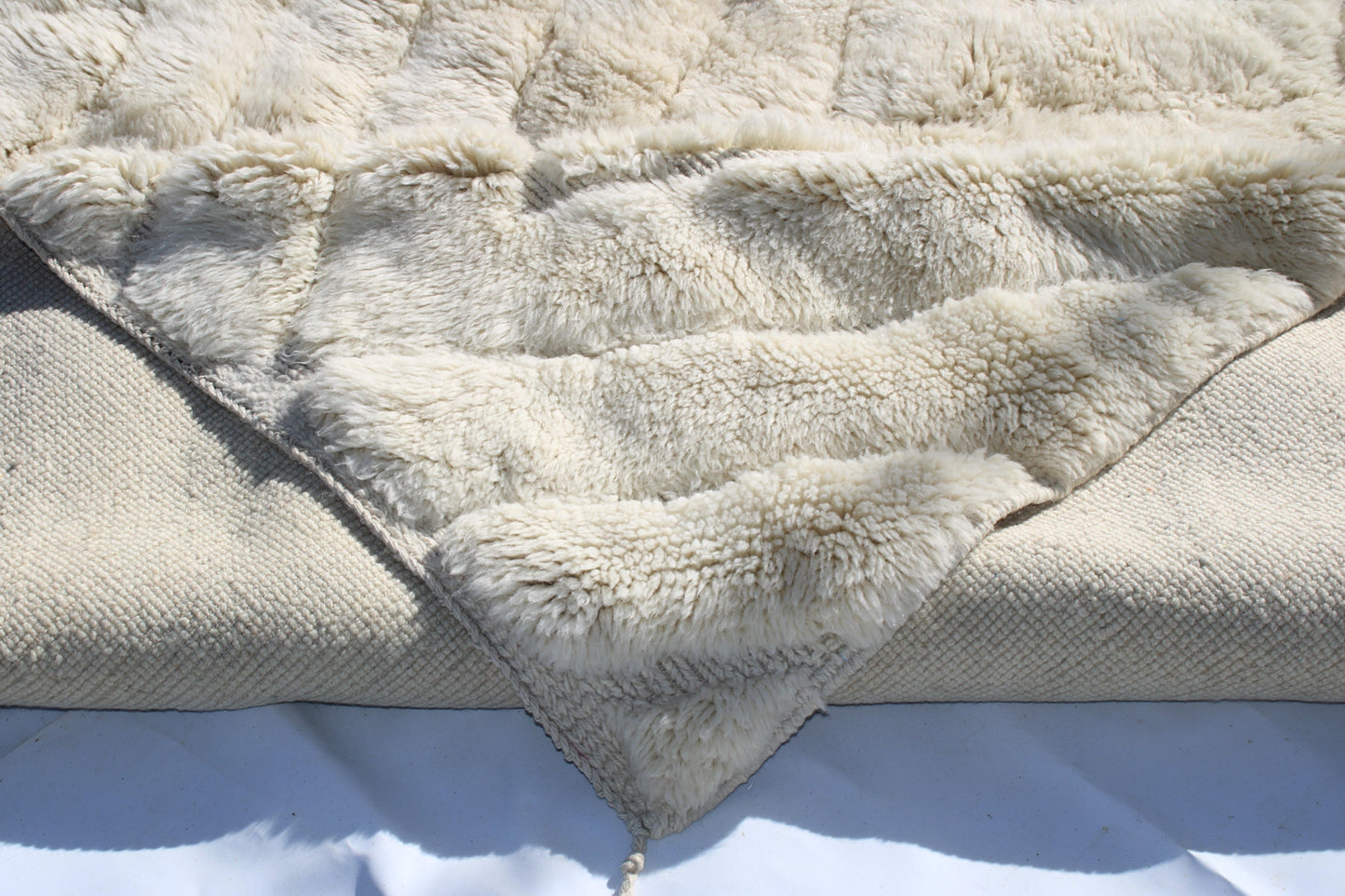 Beni Ourain rugs originate from the Atlas Mountains of Morocco and are characterized by their distinctive, neutral-toned, and geometric designs. These handwoven rugs often feature a plush pile and are made by the Berber tribes, size is 300x200 cm