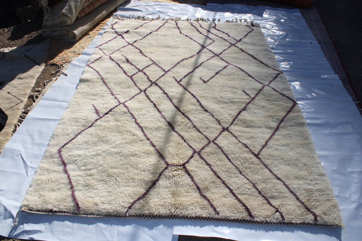 Beni Ourain rugs originate from the Atlas Mountains of Morocco and are characterized by their distinctive, neutral-toned, and geometric designs. These handwoven rugs often feature a plush pile and are made by the Berber tribes, size is 310x210 cm