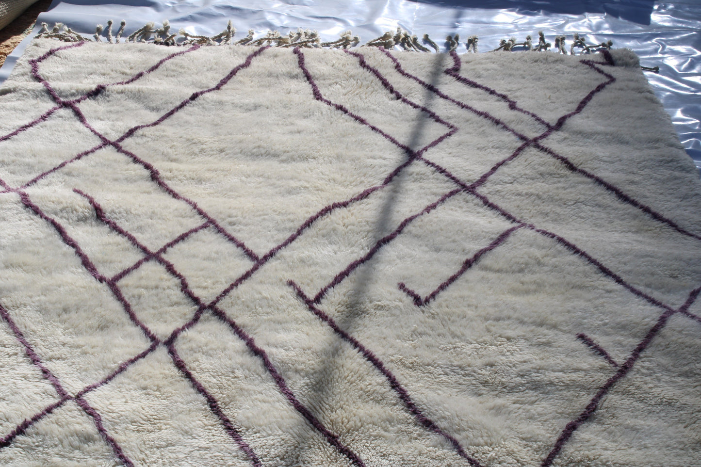 Beni Ourain rugs originate from the Atlas Mountains of Morocco and are characterized by their distinctive, neutral-toned, and geometric designs. These handwoven rugs often feature a plush pile and are made by the Berber tribes, size is 310x210 cm